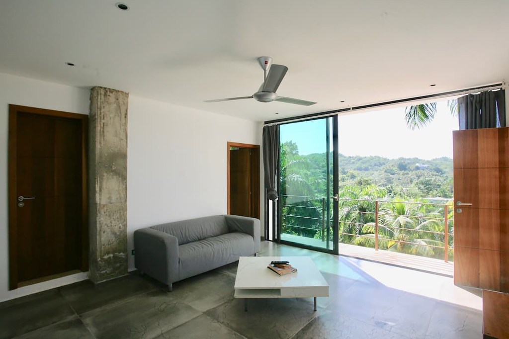 A living room with sliding glass doors is pictured. 