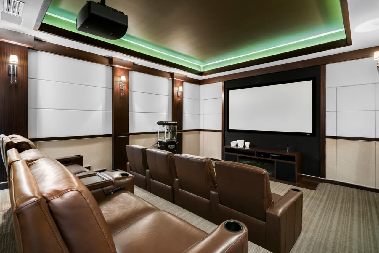 The theater is appointed with leather lounges and a popcorn machine.