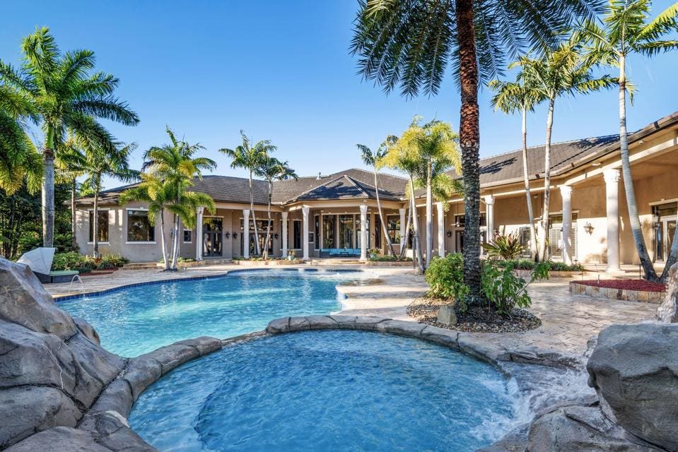 A Florida backyard features a waterfall and the waterslide.