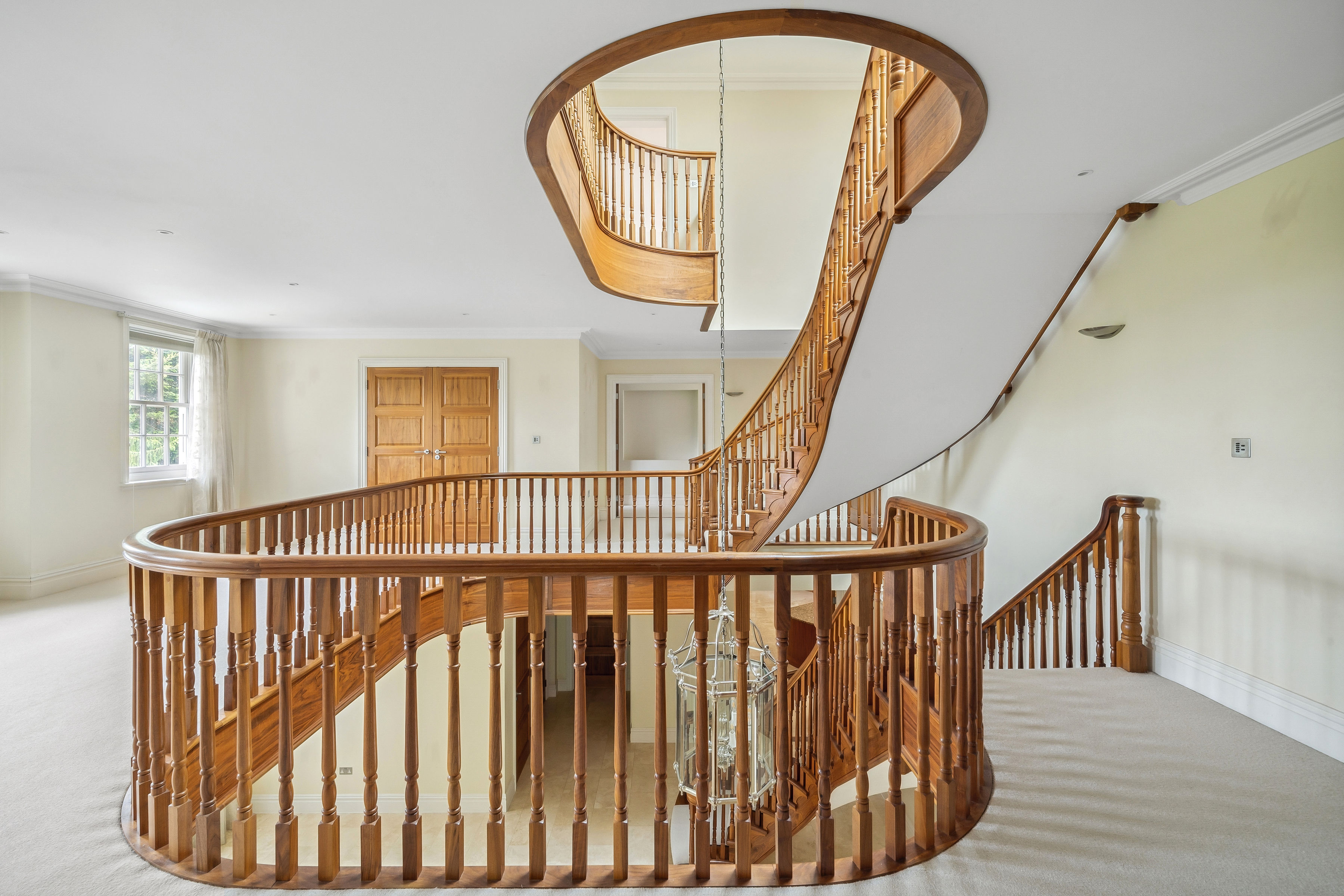 The wooden staircase spirals through the middle