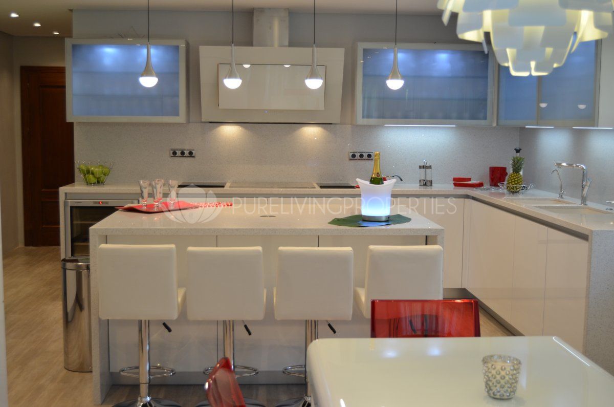 The kitchen is finished with a white gloss effect finish