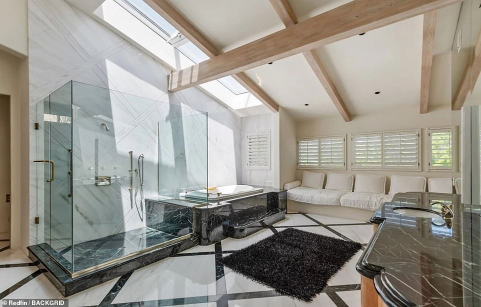 The en suite bathroom has skylights, a soaking tube and steam shower and granite countertops on the vanities