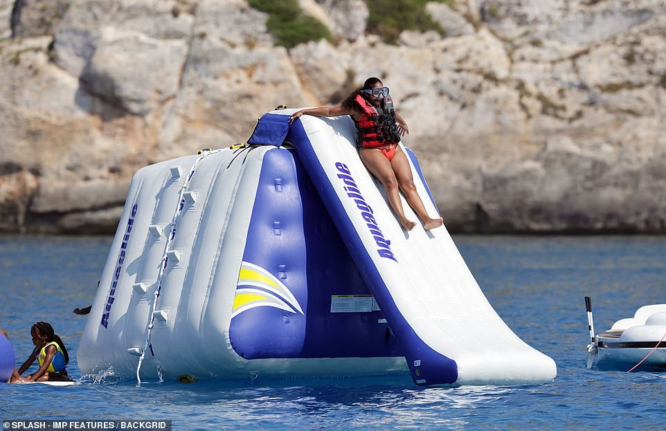 Here we go! Paige appeared delighted as she whizzed down the inflatable slide